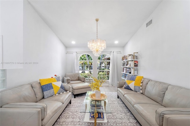 living room featuring light wood-type flooring and a chandelier