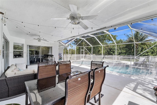 view of pool with ceiling fan, an outdoor hangout area, a jacuzzi, glass enclosure, and a patio area