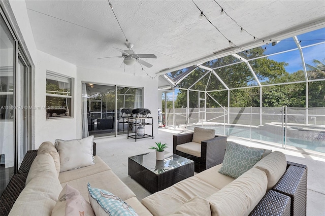 view of patio / terrace featuring outdoor lounge area, a fenced in pool, a lanai, and ceiling fan