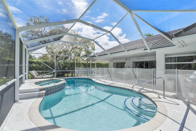 view of pool with an in ground hot tub, glass enclosure, and a patio area