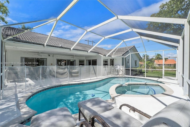 view of pool with glass enclosure and a patio