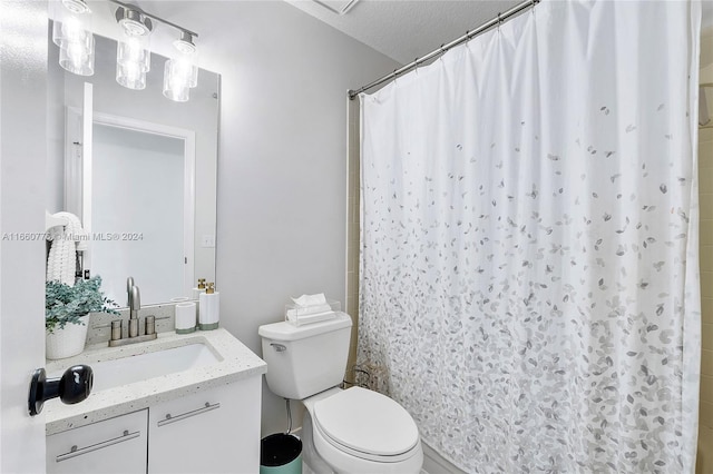 bathroom with a textured ceiling, walk in shower, vanity, and toilet