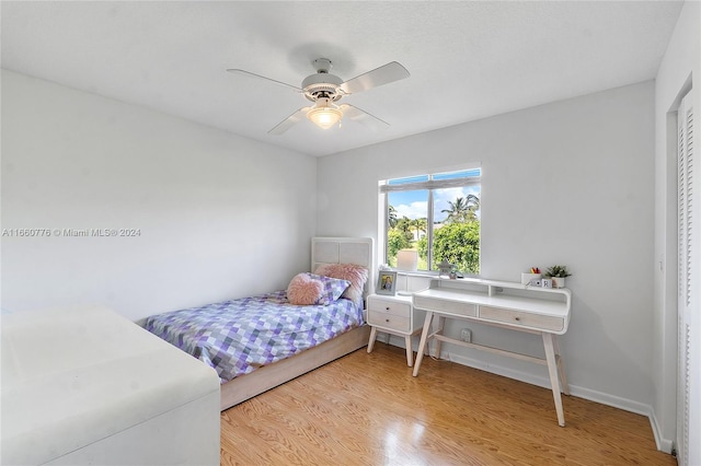 bedroom with ceiling fan and hardwood / wood-style flooring