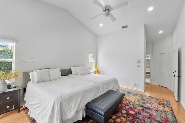 bedroom featuring high vaulted ceiling, light wood-type flooring, and ceiling fan