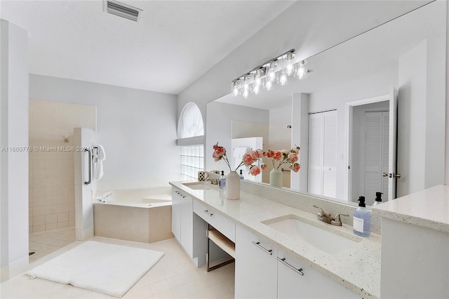 bathroom with vanity, plus walk in shower, and tile patterned floors