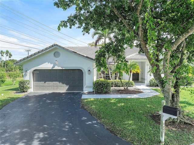 view of front of home featuring a front yard and a garage