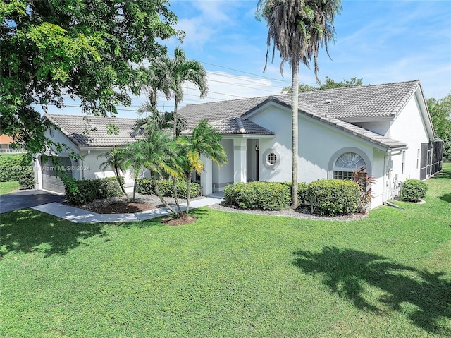 view of front facade featuring a front yard and a garage