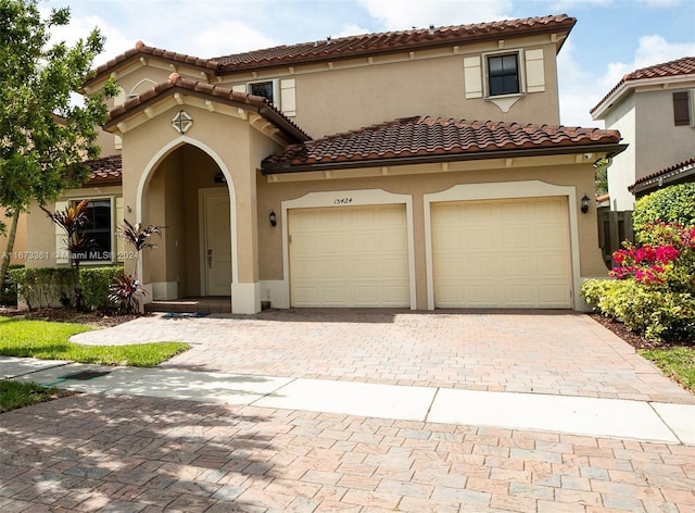 mediterranean / spanish house with a garage