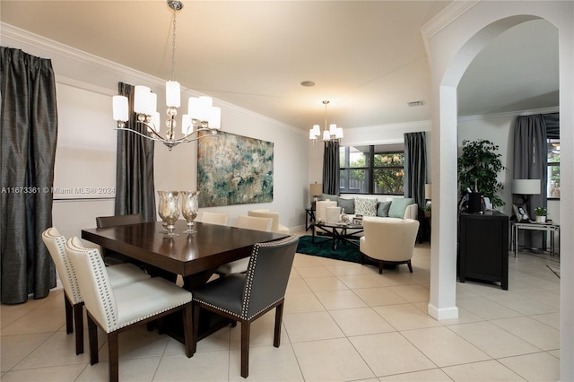 tiled dining area featuring crown molding and an inviting chandelier