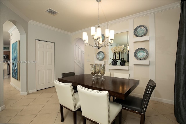 tiled dining space featuring a chandelier and ornamental molding