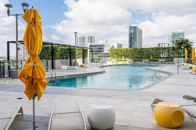 community pool featuring a patio area and a city view