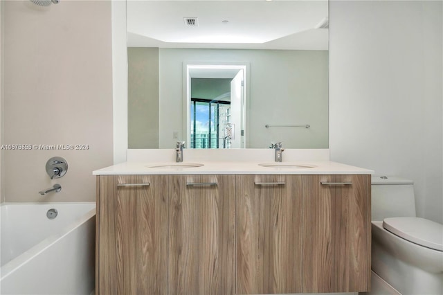 full bath featuring double vanity, visible vents, a sink, and toilet