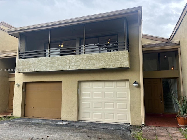 exterior space featuring a balcony and a garage