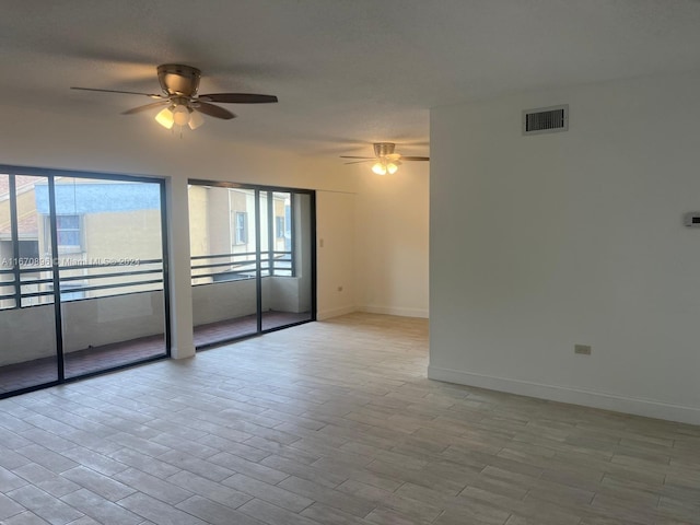 empty room with light hardwood / wood-style flooring and ceiling fan