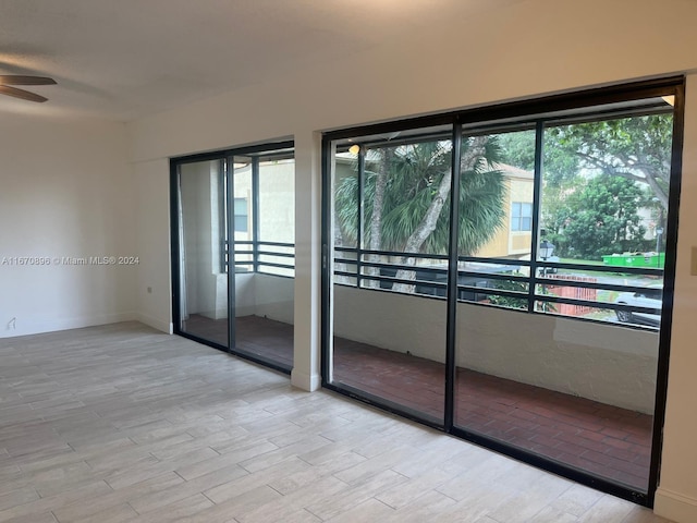 unfurnished room featuring ceiling fan, a wealth of natural light, and light hardwood / wood-style flooring