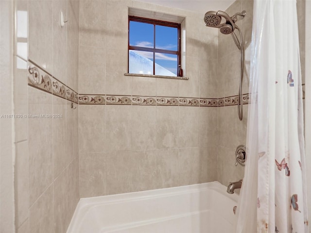 bathroom with shower / tub combo with curtain