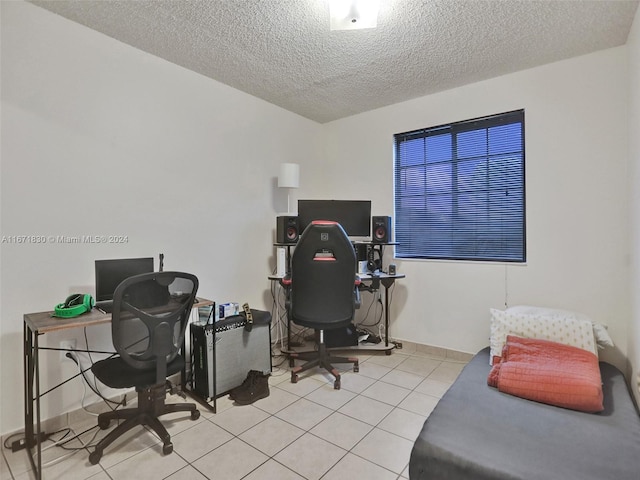 office space with a textured ceiling and light tile patterned floors