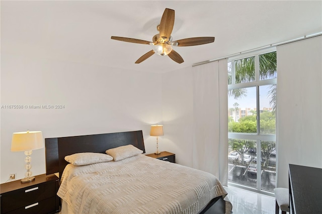 bedroom featuring ceiling fan, floor to ceiling windows, and access to outside