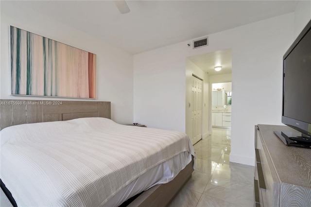 bedroom featuring ensuite bathroom and ceiling fan