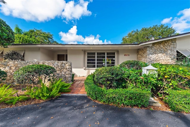 11420 SW 80th Rd, Pinecrest, FL 33156 - property entrance with stone siding and stucco siding