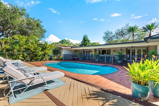 11420 SW 80th Rd, Pinecrest, FL 33156 - pool with a patio, a wooden deck, a ceiling fan, french doors, and fence