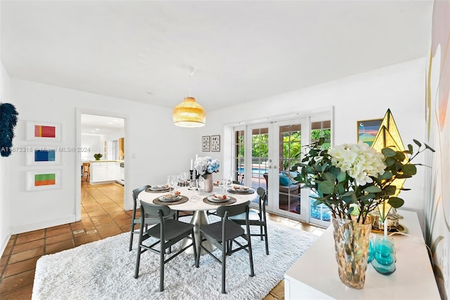 dining space featuring french doors and light tile patterned floors