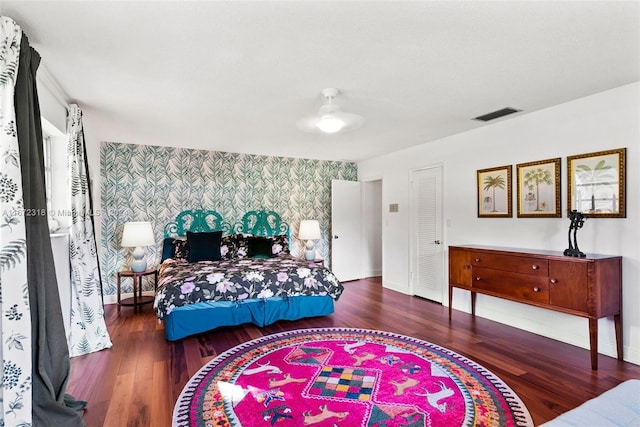 bedroom with dark hardwood / wood-style flooring