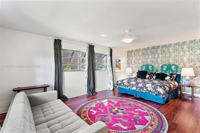 bedroom with dark wood-type flooring and a textured ceiling