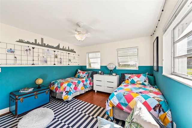 bedroom with ceiling fan and dark wood-type flooring