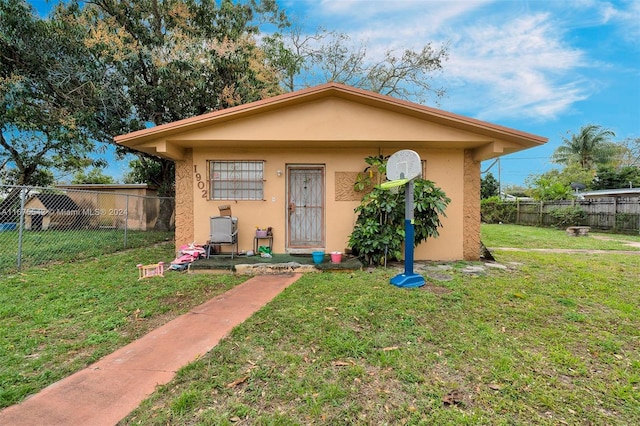 bungalow-style house featuring a front yard