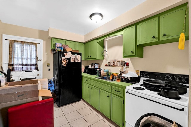 kitchen with light tile patterned flooring, sink, green cabinetry, electric range, and black refrigerator