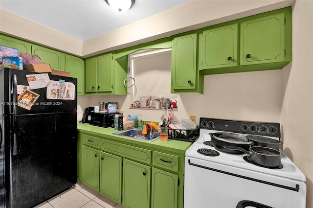 kitchen featuring light tile patterned floors, white electric stove, green cabinetry, and black refrigerator