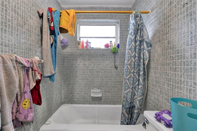 bathroom featuring shower / bath combination with curtain, ornamental molding, and toilet