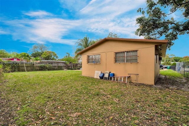 view of side of home with a lawn