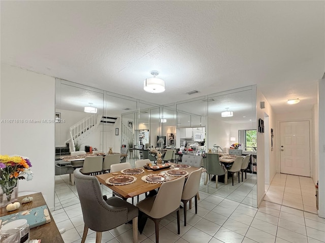 dining room with light tile patterned floors and a textured ceiling