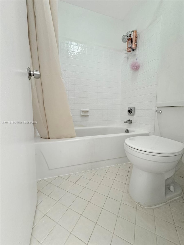 bathroom with tile patterned flooring, toilet, and shower / tub combo with curtain