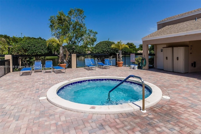 view of swimming pool featuring a community hot tub and a patio