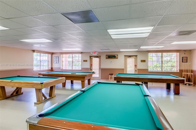 rec room with a drop ceiling, a healthy amount of sunlight, and billiards