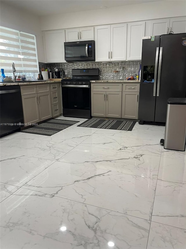 kitchen with black appliances, sink, gray cabinetry, and backsplash