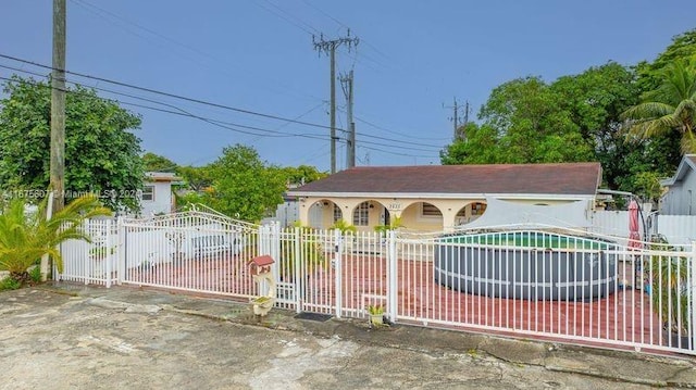 view of gate featuring a pool