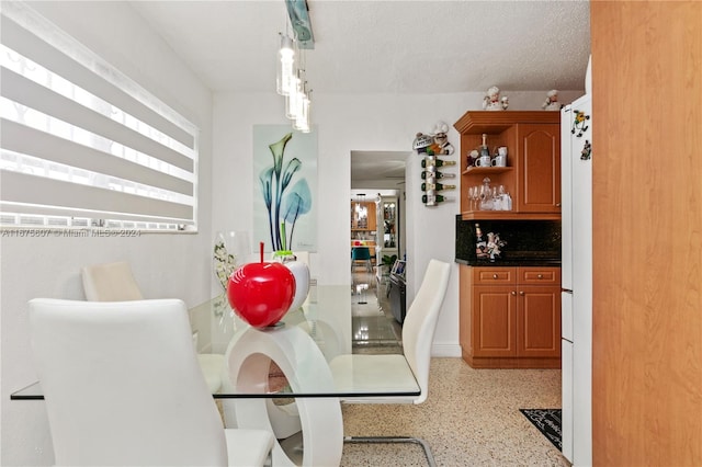 dining area featuring a textured ceiling