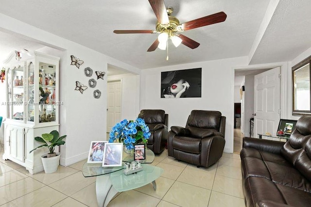 living room featuring light tile patterned flooring and ceiling fan