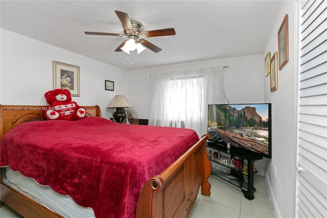 tiled bedroom featuring ceiling fan