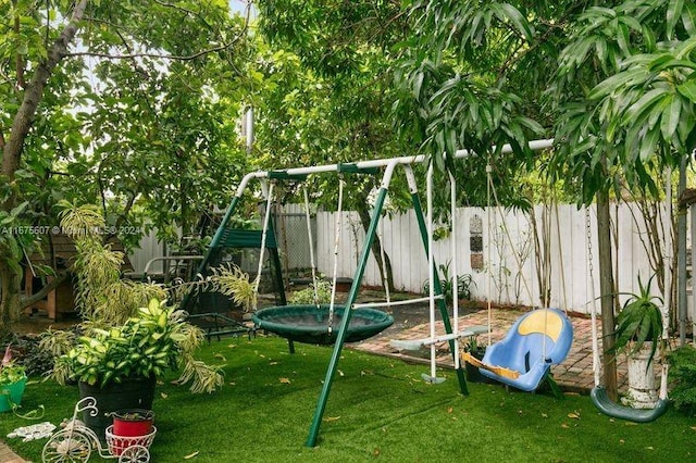 view of jungle gym featuring a trampoline and a yard