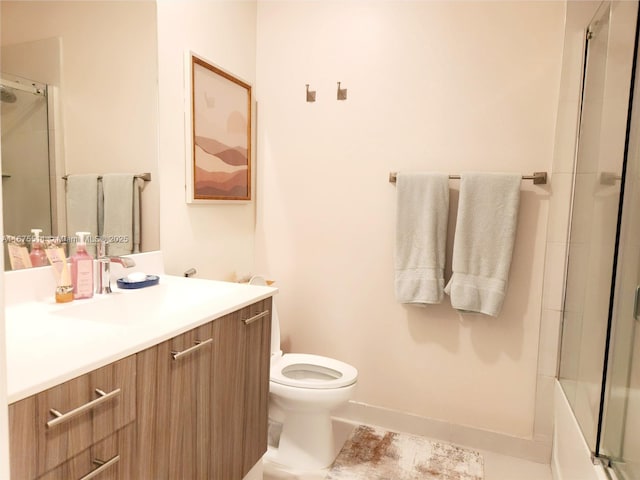 full bathroom featuring toilet, bath / shower combo with glass door, and vanity