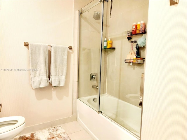 bathroom with toilet, bath / shower combo with glass door, and tile patterned floors