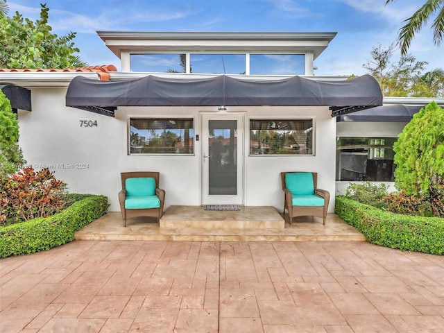 property entrance featuring a patio area