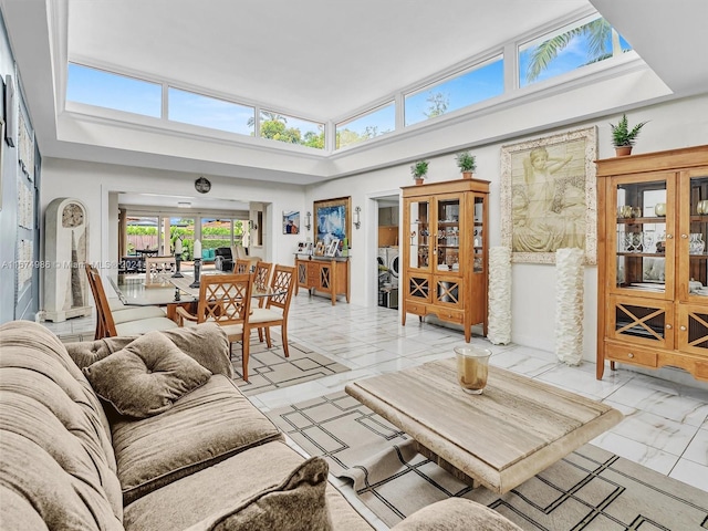 living room featuring a towering ceiling and light tile patterned flooring