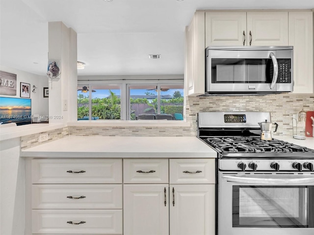 kitchen with white cabinetry, backsplash, and stainless steel appliances