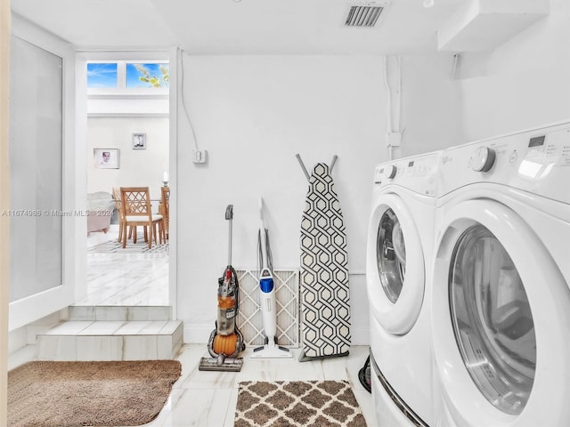 laundry room with washing machine and clothes dryer